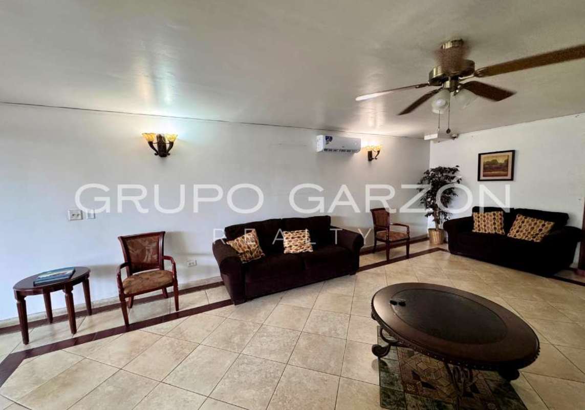 Open-plan living-dining area with balcony access, ceiling fan and ceramic tile floors at PH Sunset Place Panama City