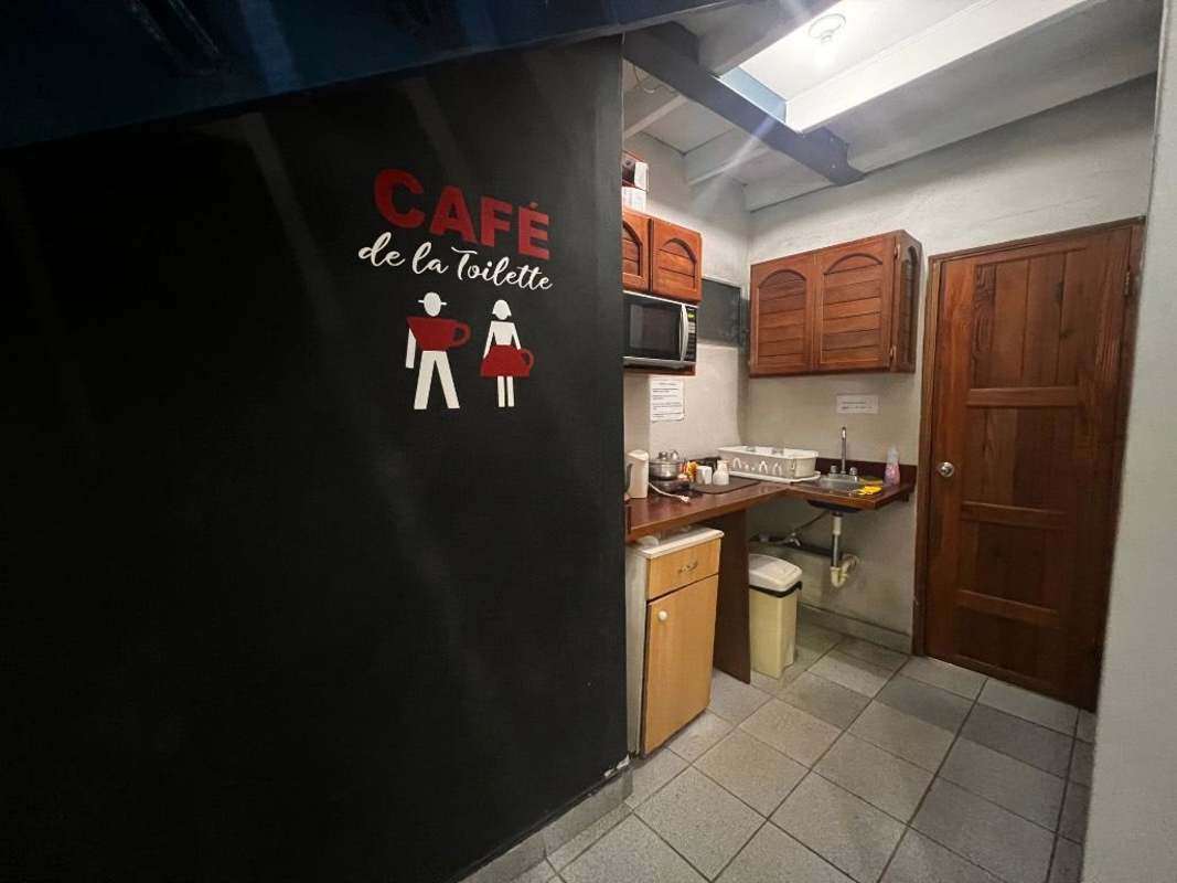 Modern office space with accent wall, wooden stairs, tiled floors inside commercial space Llano Bonito Panama