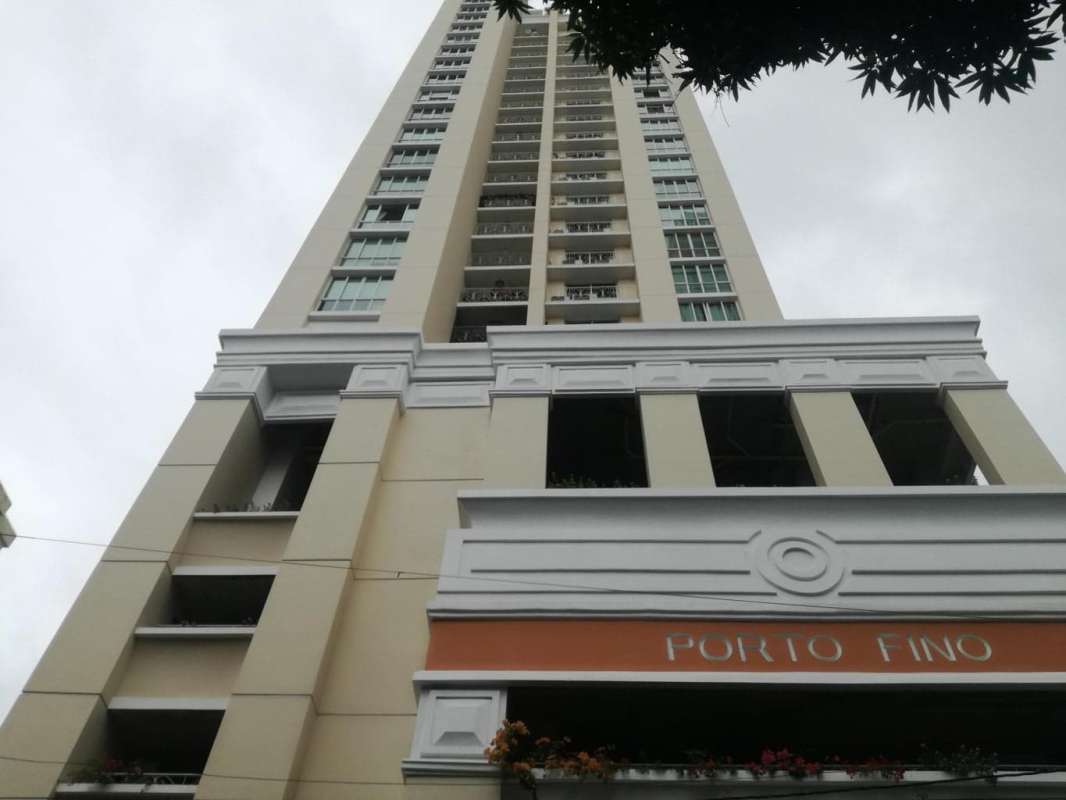 Beige and white Porto Fino high-rise with balconies and tower signage in San Francisco Panama City