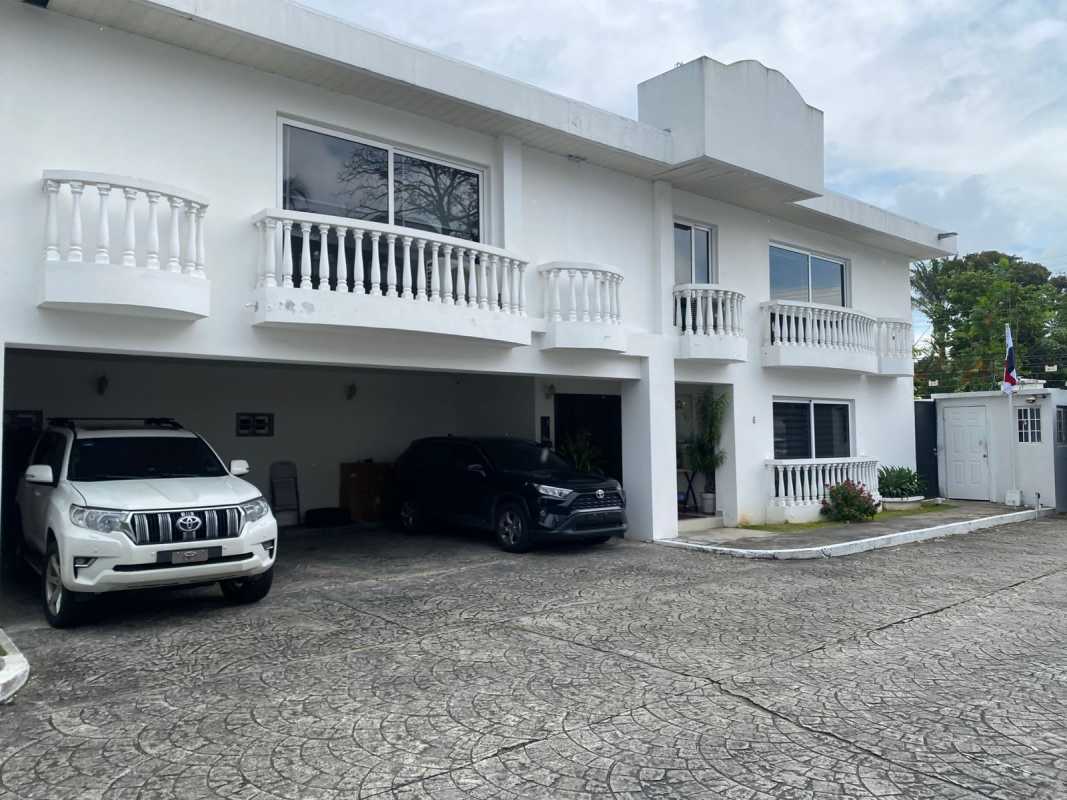 Two-story white Mediterranean-style house with balconies and garage in Altos del Golf Panama City