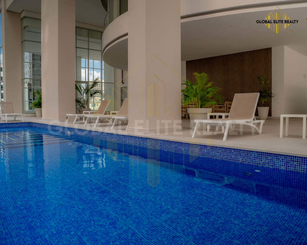 Indoor pool area with lounge chairs in PH Park Tower Obarrio luxury building Panama
