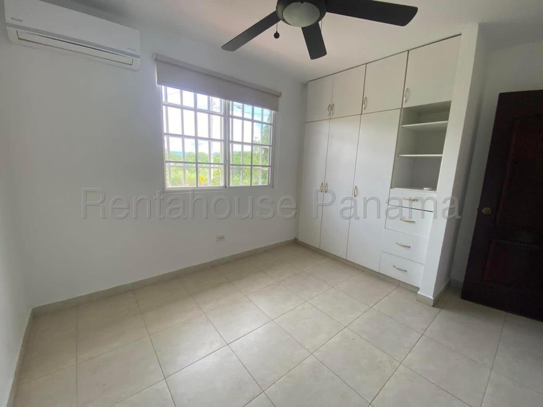 Spacious backyard with lawn, landscaping and covered terrace in Villa Valencia Costa Sur Panama