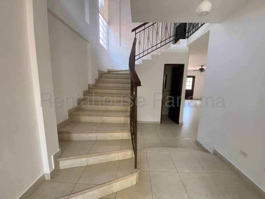 Open living room with large windows, ceramic floors and AC at Costa Sur house for rent