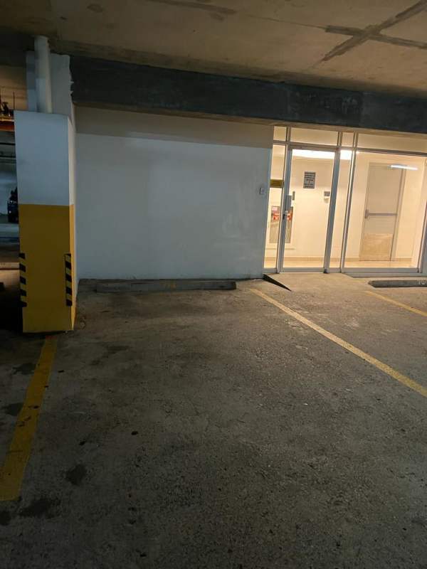 Modern bathroom with beige tiles, wall-mounted toilet, granite sink in Panama apartment rental