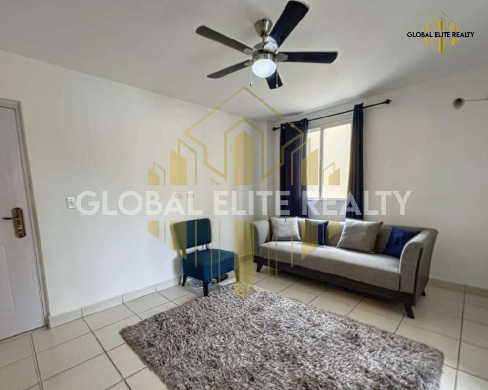 Living room with marble floors and ceiling fan in affordable Villa Lucre condo