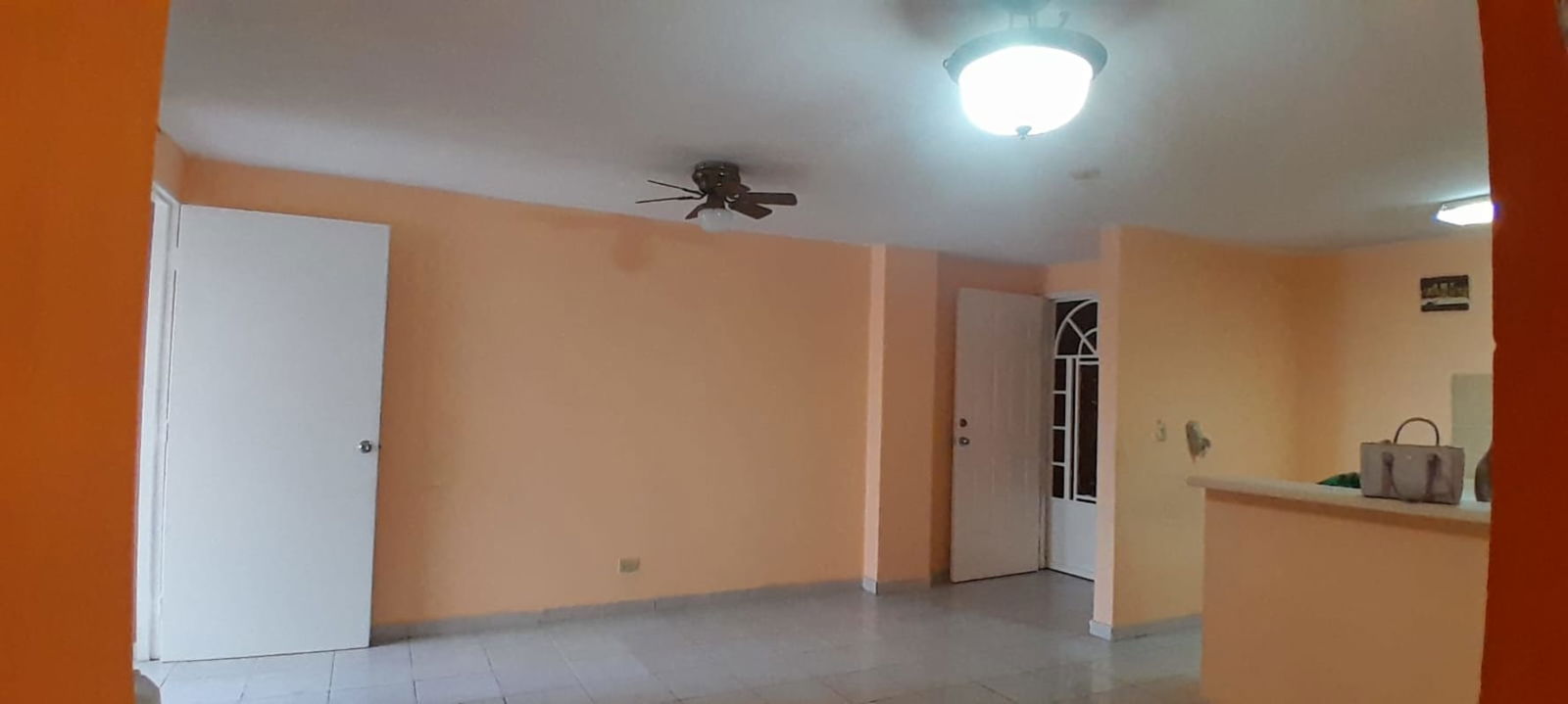 Spacious bedroom with tile floors, built-in storage, bright windows at PH Via España Residences Carrasquilla Panama