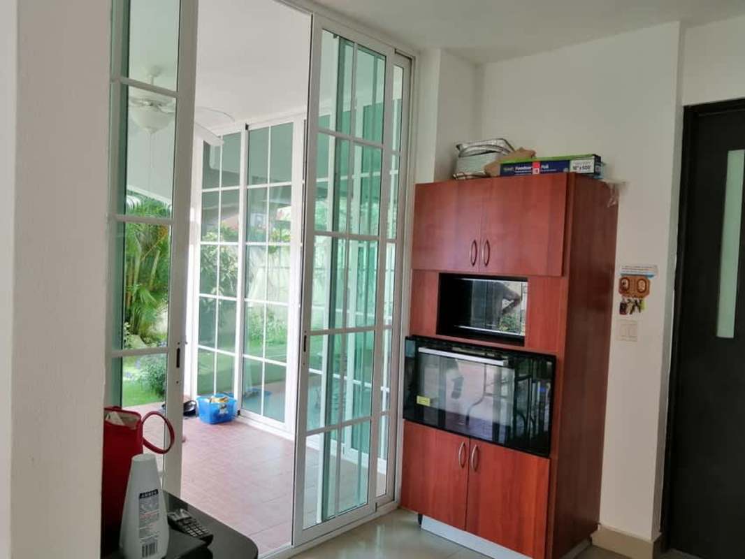 Kitchen with granite countertops, wooden cabinets and appliances inside residential house in Clayton Panama