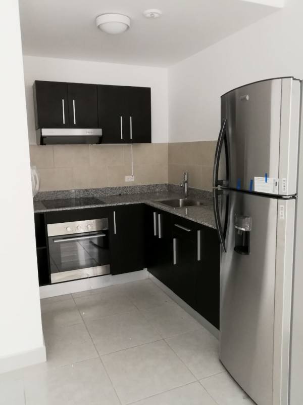 Master bedroom with large window, AC, ceiling fan, ceramic tile floors in PH Bay View Panama City