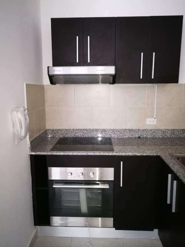 Modern open kitchen with granite countertops, electric stove, oven in PH Bay View Panama City