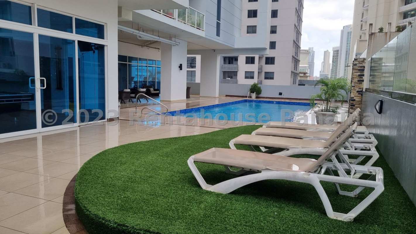 Tower rooftop pool with lounge chairs and skyline view at PH Bella Vista Loft Panama