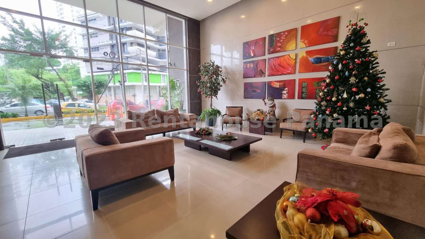 Spacious double-height modern living room with large windows at PH Bella Vista Loft Panama