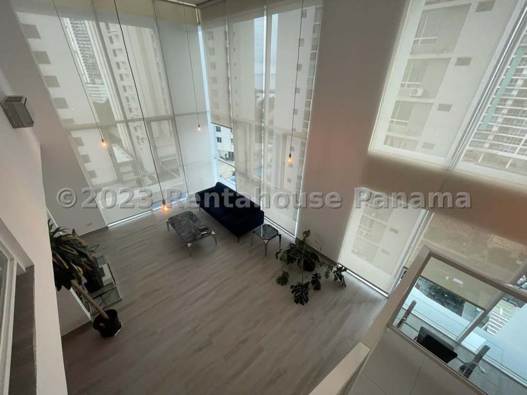 Fitness gym with equipment and large windows at PH Bella Vista Loft Panama