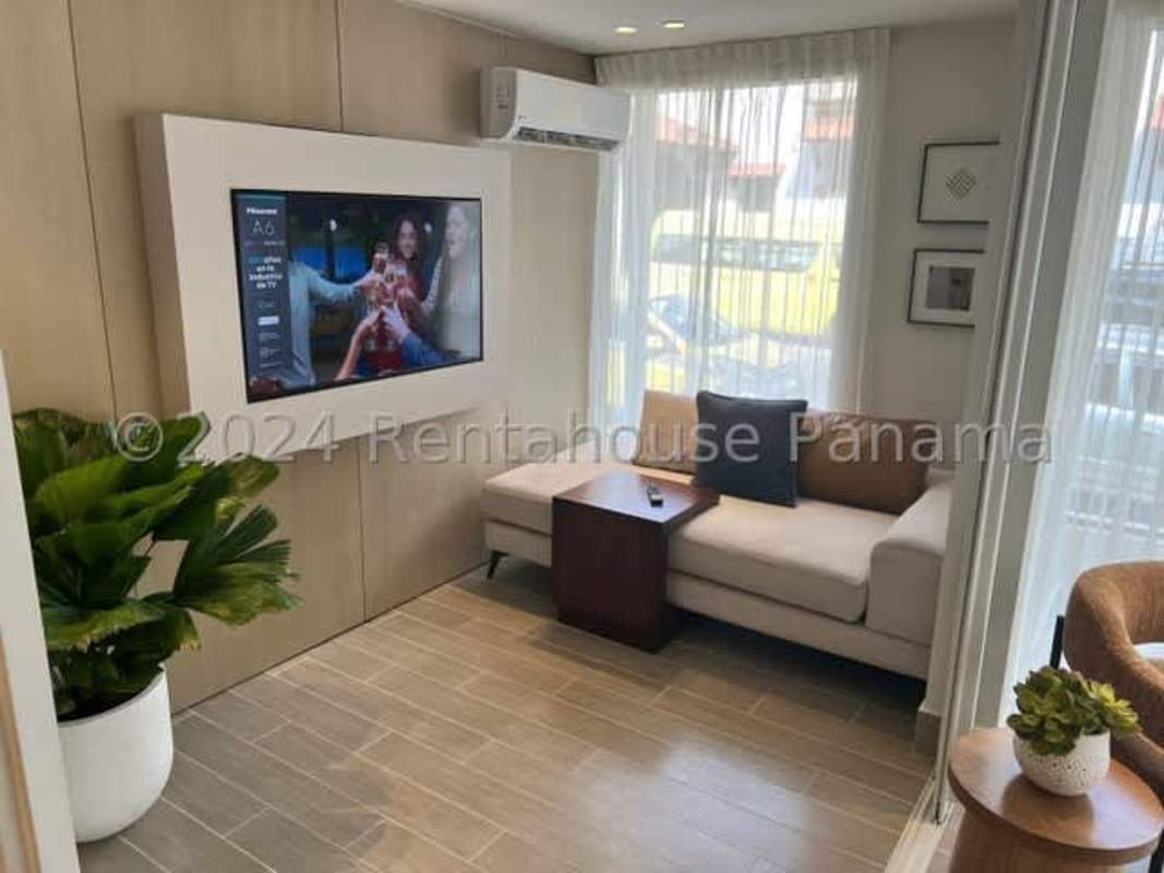 Open-plan living room and kitchen with large windows at PH Bella Vista Residences