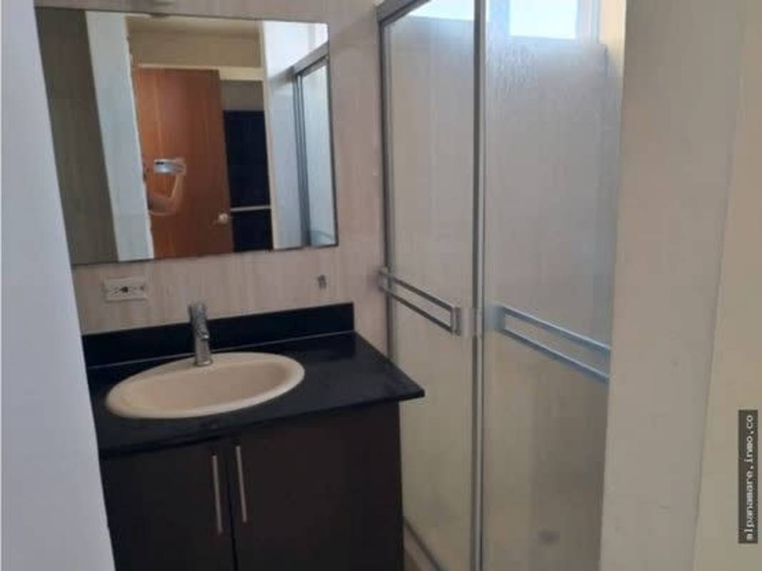 Modern bathroom with granite vanity top, mirror, and glass shower PH Hato Pintado Park Panama City