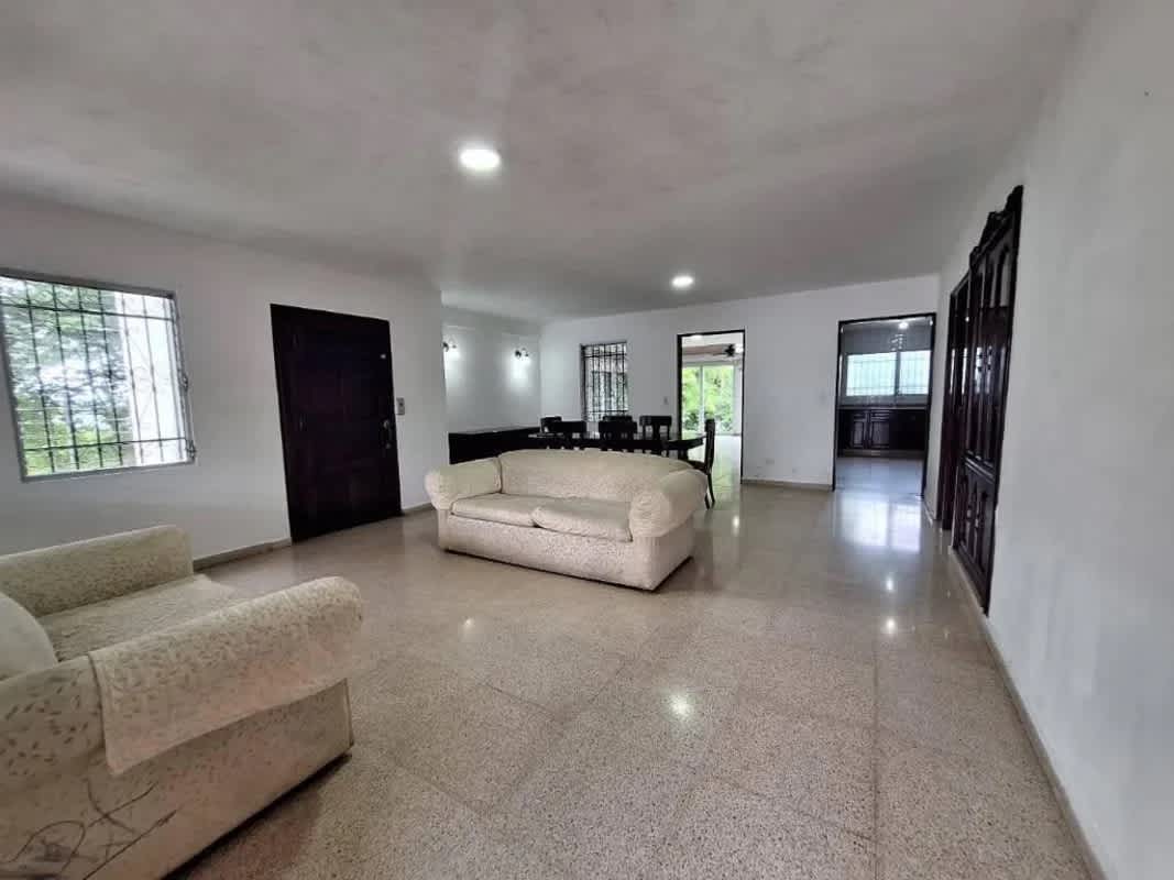 Spacious living dining room with tiled floor, white walls, access to balcony El Dorado Panama