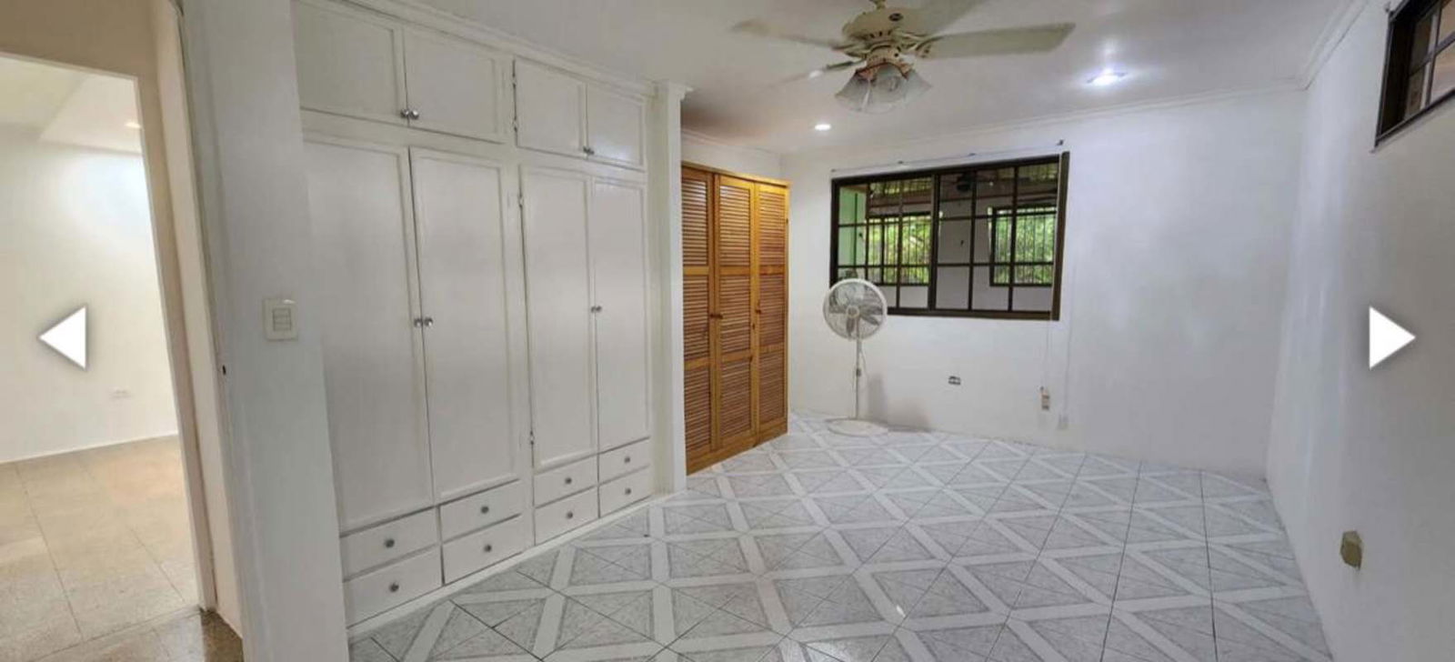 Spacious master bedroom with ensuite bathroom and closet in Santa Clara home, Panama City