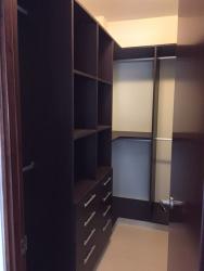 Spacious walk-in closet with dark cabinetry PH River Valley Panama