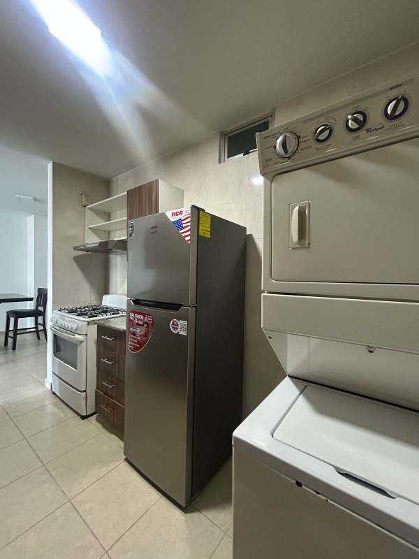 Kitchen with granite counters stacked washer dryer PH El Cangrejo Tower Panama