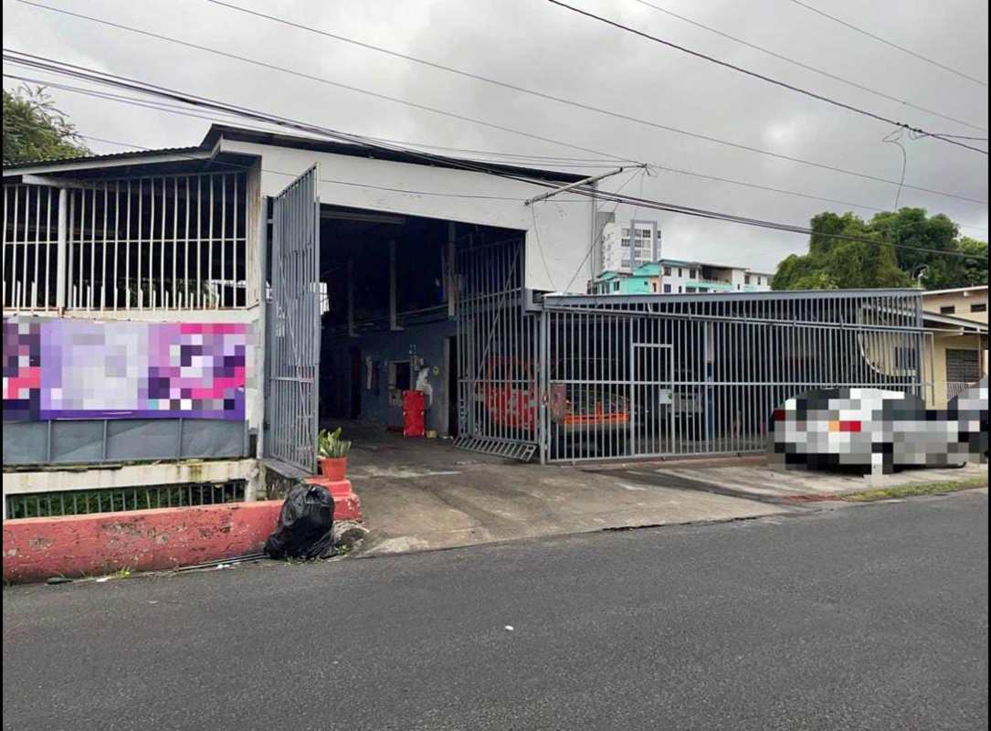 Simple office with tiled floor, red and white walls inside commercial warehouse in Parque Lefevre Panama