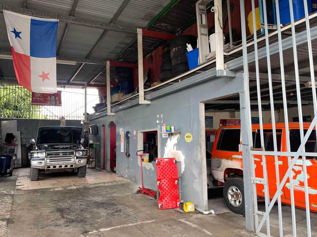 Interior bay area of commercial vehicle service workshop with cars in Parque Lefevre Panama City