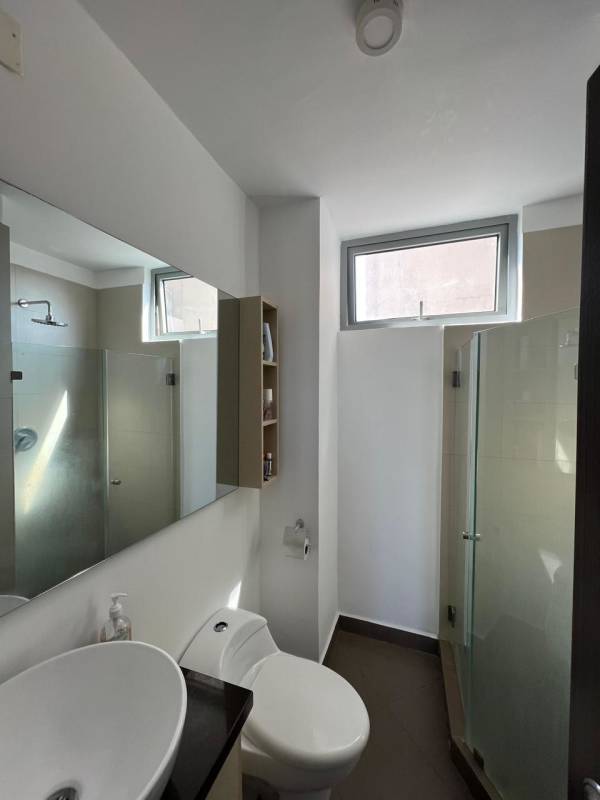 Modern bathroom with glass shower, floating vanity and window at PH Vista Hermosa Panama City