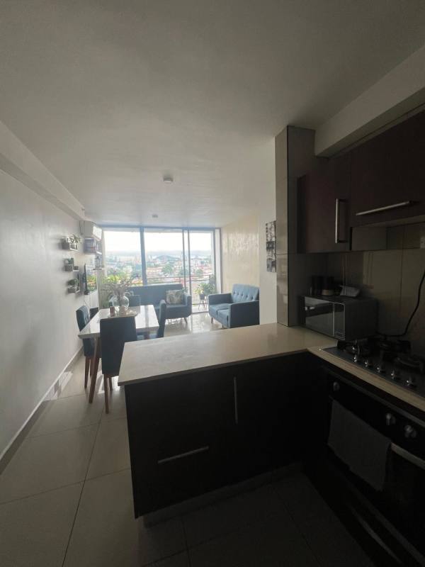 Contemporary kitchen with appliances, dining area and panoramic windows in PH Vista Hermosa Panama City