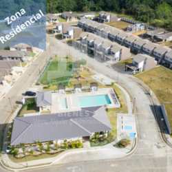 Aerial image showing houses, pool, clubhouse and courts in Costa Verde housing project, Panama