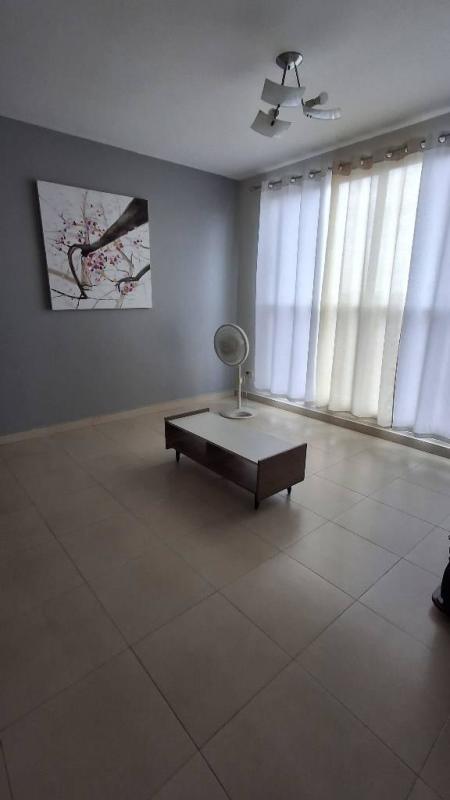 Bedroom with built-in closet, tile floors, and split AC in Versalles Compound apartment Panama City