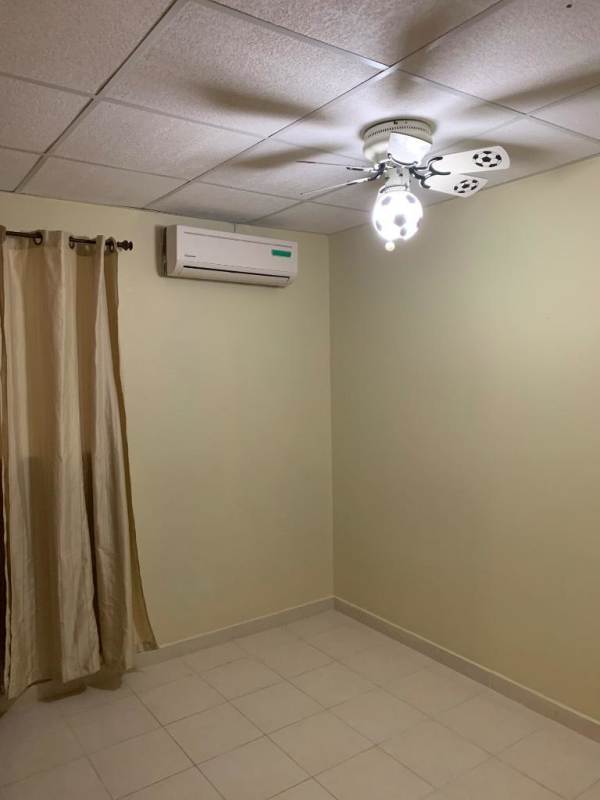 Empty bedroom outfitted with split AC unit, ceiling fan and curtained window Ciudad San Lorenzo La Cabima