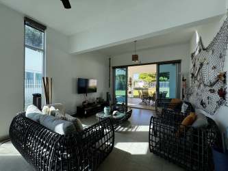 Spacious covered patio with ceiling fan facing private pool and backyard Playa Blanca Panama