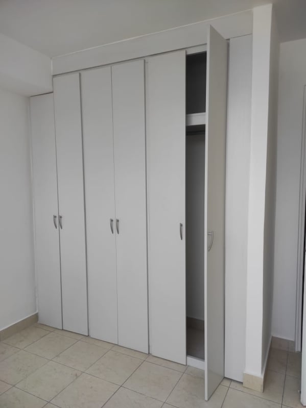 Bedroom with white built-in closets tiled floor Edison Park Panama City