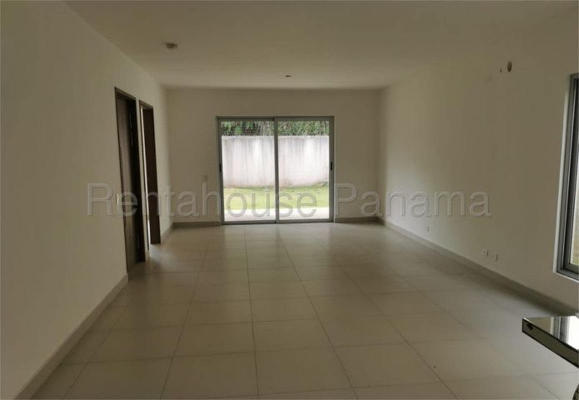 Bright living area with sliding doors to garden, neutral ceramic tile Altos del Parque