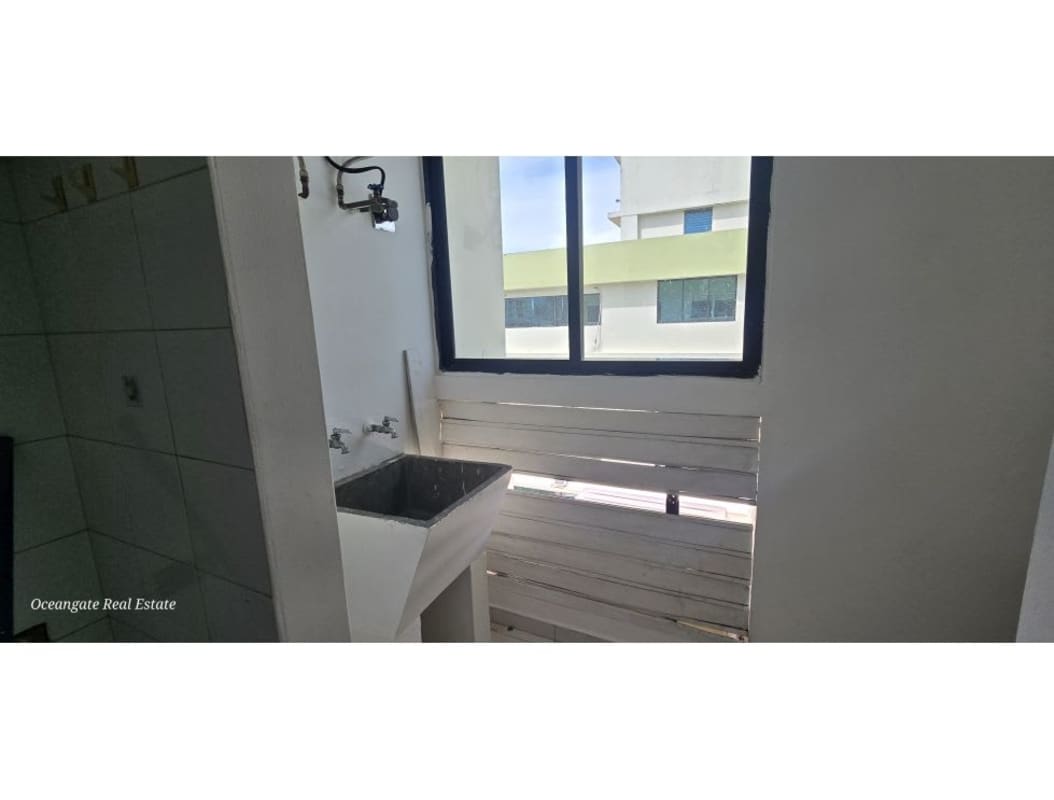 Bright laundry with sink, window, tiled walls in PH Royal Center San Francisco Panama