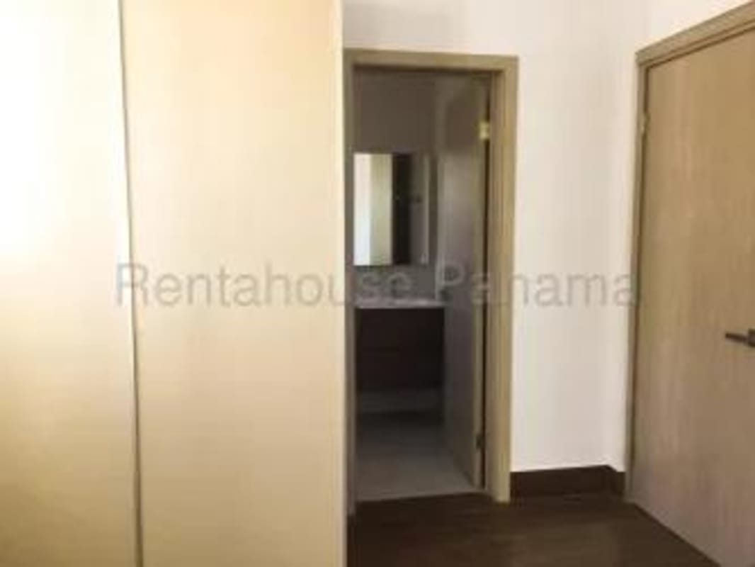 Master bedroom with ensuite bath, large window and closet in Costa Sur Panama apartment