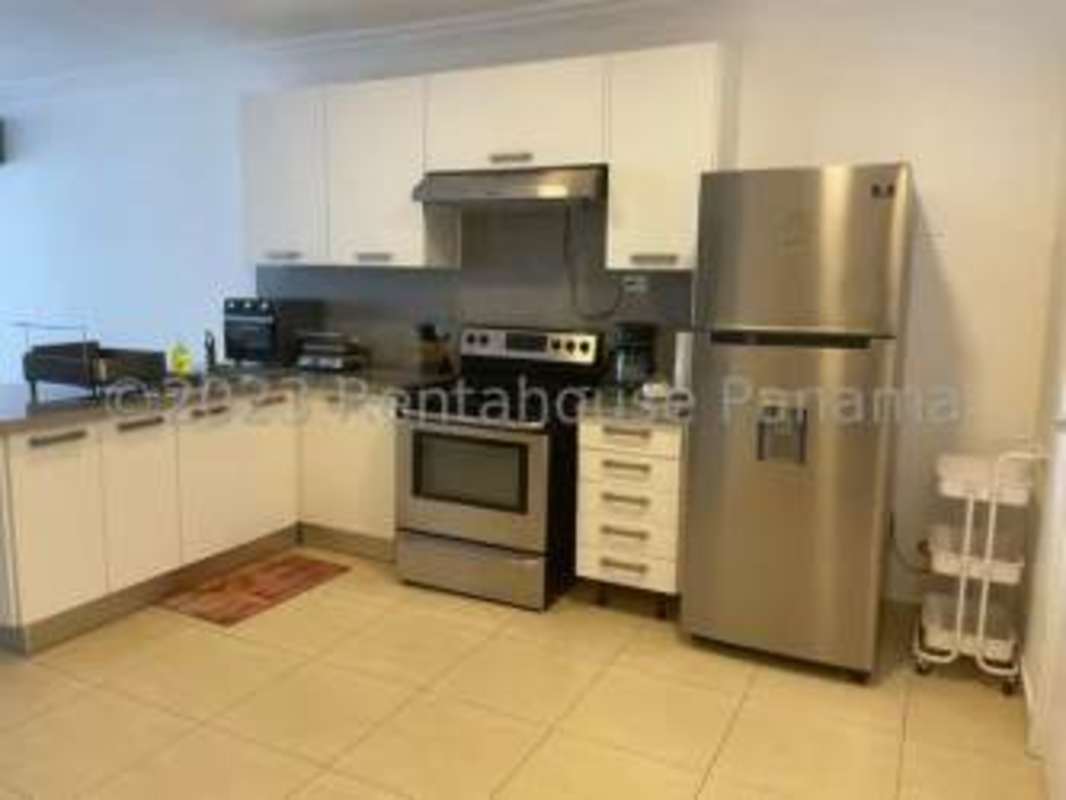 Kitchen with white cabinets, stove, stainless refrigerator PH Yacht Club Tower Avenida Balboa