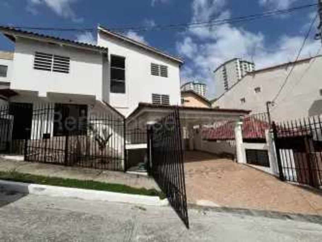 View of driveway and gated front yard contemporary house Panama City