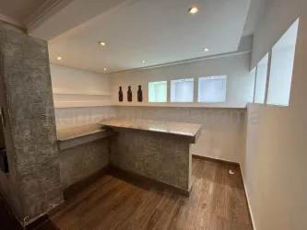 Kitchen bar area concrete countertops recessed lighting open shelving rental Panama