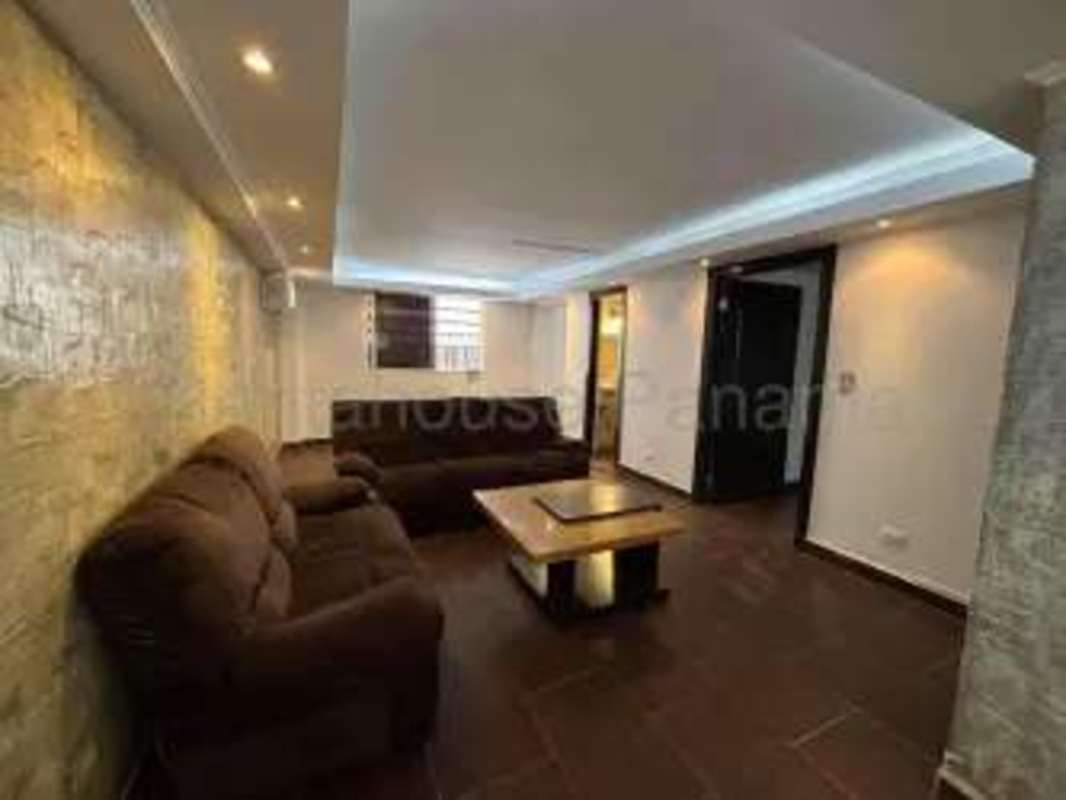 Living room brown sofas stone accent wall recessed lighting contemporary design Panama