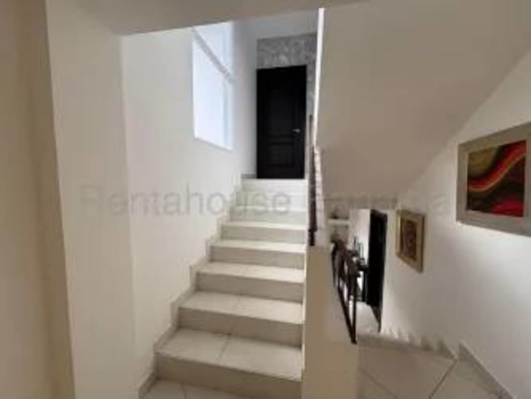 Bright staircase white walls large window modern chandelier panoramic view rental Panama