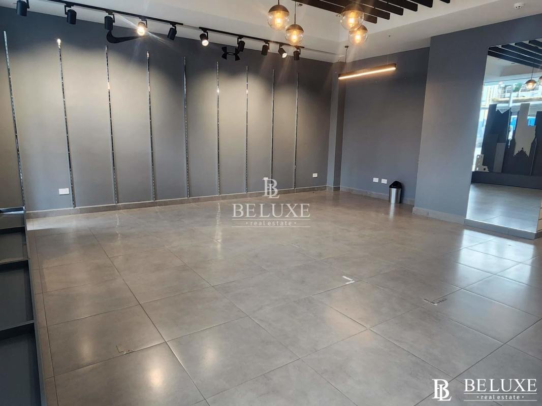 Modern commercial interior with tiled floor, track lighting, large mirror in San Francisco Panama