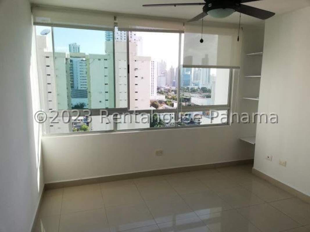 Modern kitchen with black countertops, cabinetry, balcony door and city view at PH Citrus Panama