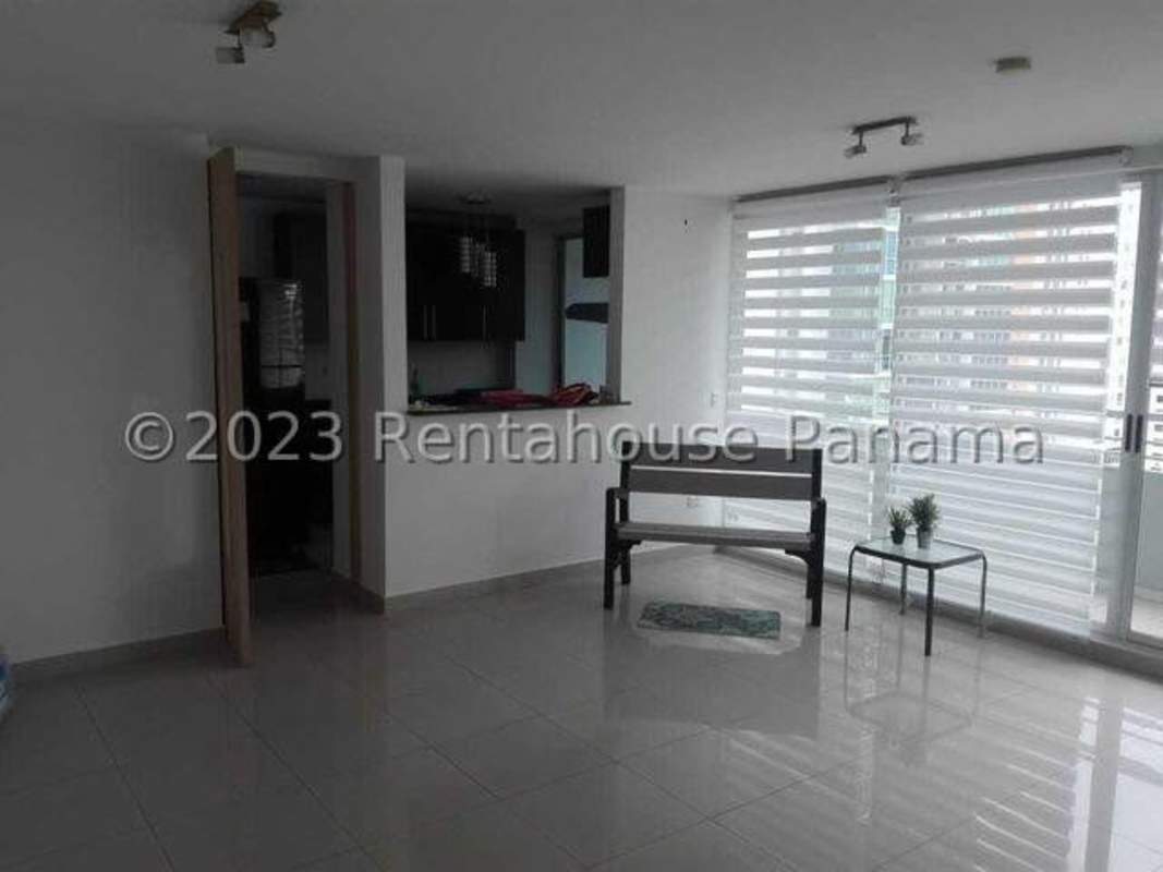 Bright living room with floor-to-ceiling windows, porcelain tiles, open kitchen in PH Citrus San Francisco Panama