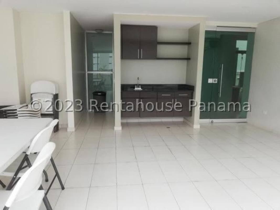 Multipurpose social room with kitchenette and glass door divider at PH Citrus San Francisco Panama