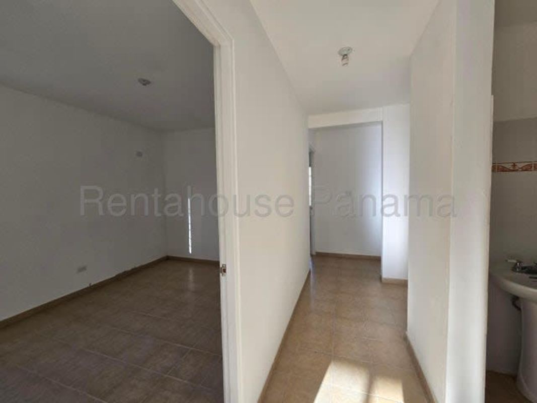 Small bathroom with white ceramic tiles pedestal sink in house for sale Pacora Panama