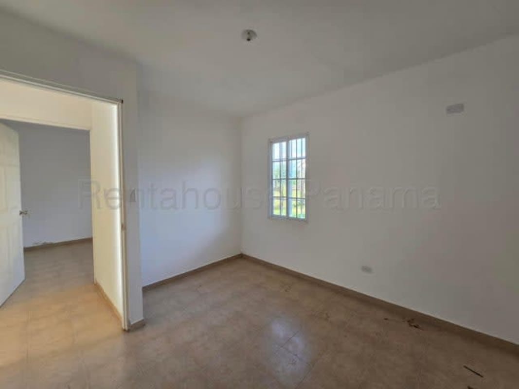 Single-story house with fenced large yard under blue sky for sale in Pacora Panama