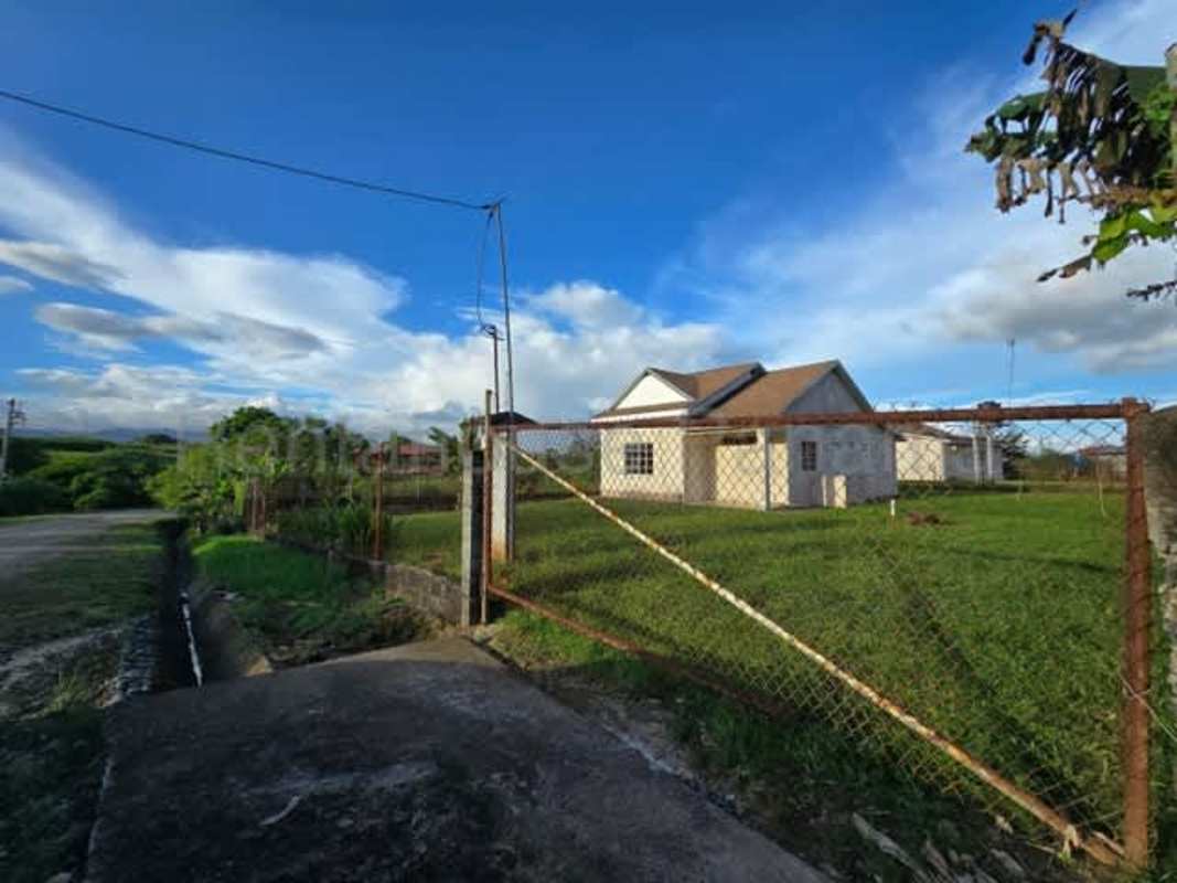 Kitchen area with vaulted ceiling large window tile countertop Pacora house