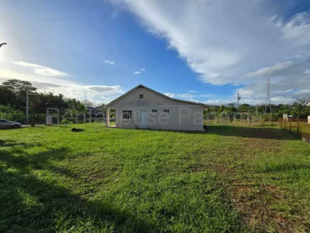 Single-story home with fenced yard in quiet suburban Pacora close-up