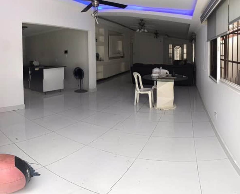 Large bright open dining and living area with ceramic flooring in Brisas del Golf Panama house