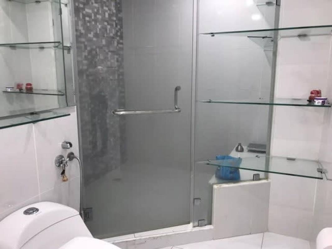 Bright bedroom with tile floors and built-in wardrobes in Brisas del Golf house Panama