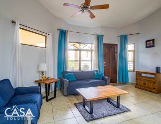 Living area with sofas, tile floors and windows in Cuesta del Sol David Panama